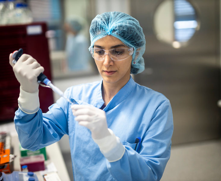 Researcher pipetting in cleanroom
